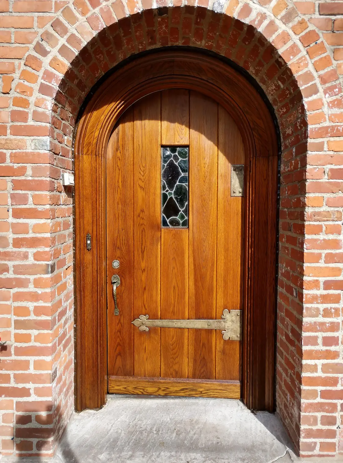 The same door after: warm, freshly finished wood