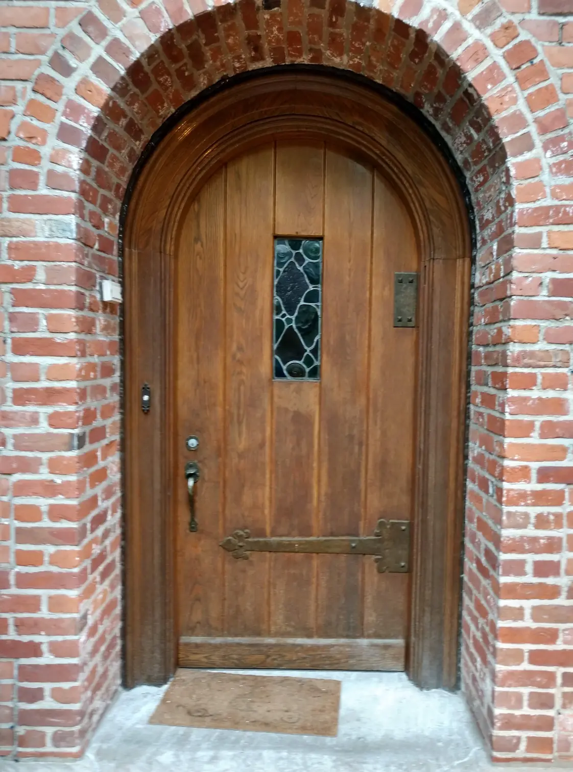 Arched door before: weathered, grey finish