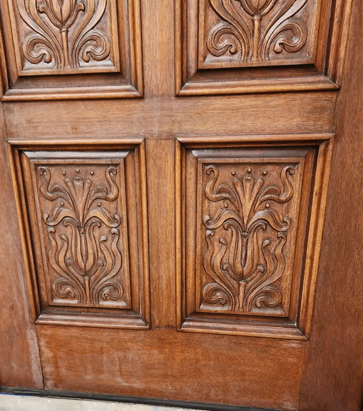 Carved door panels before the work, in their old dark finish