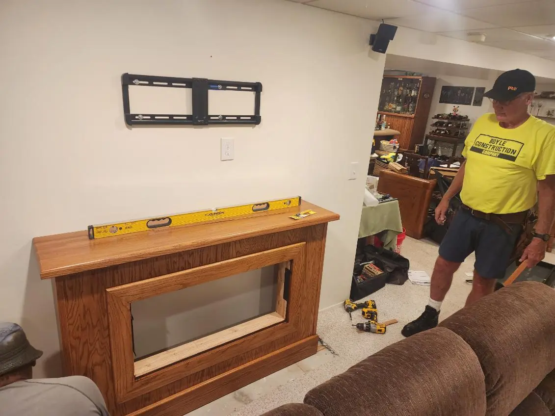 The surround in place with a level resting on the mantel