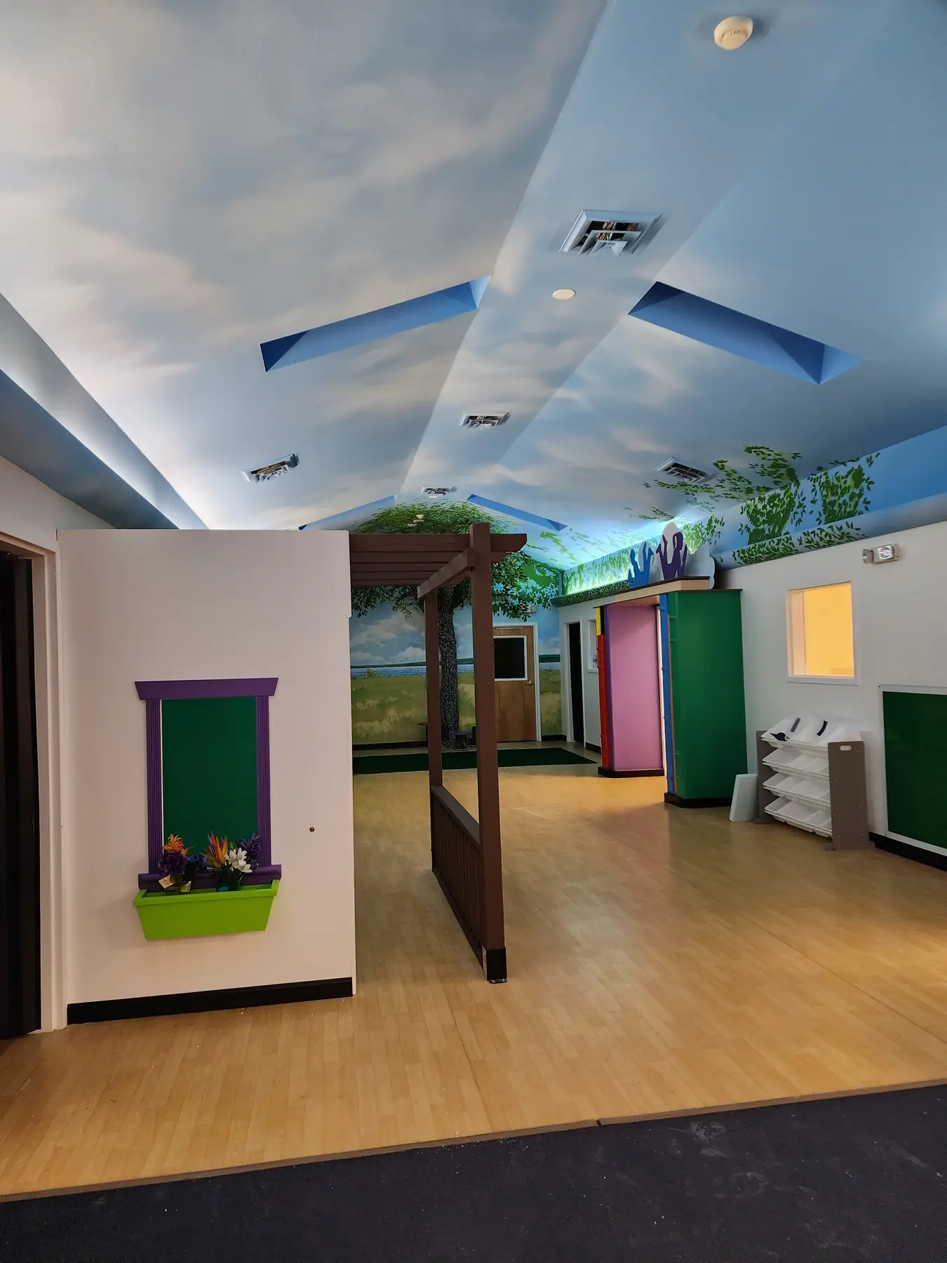 Child care hallway with window boxes, an arbor and painted walls