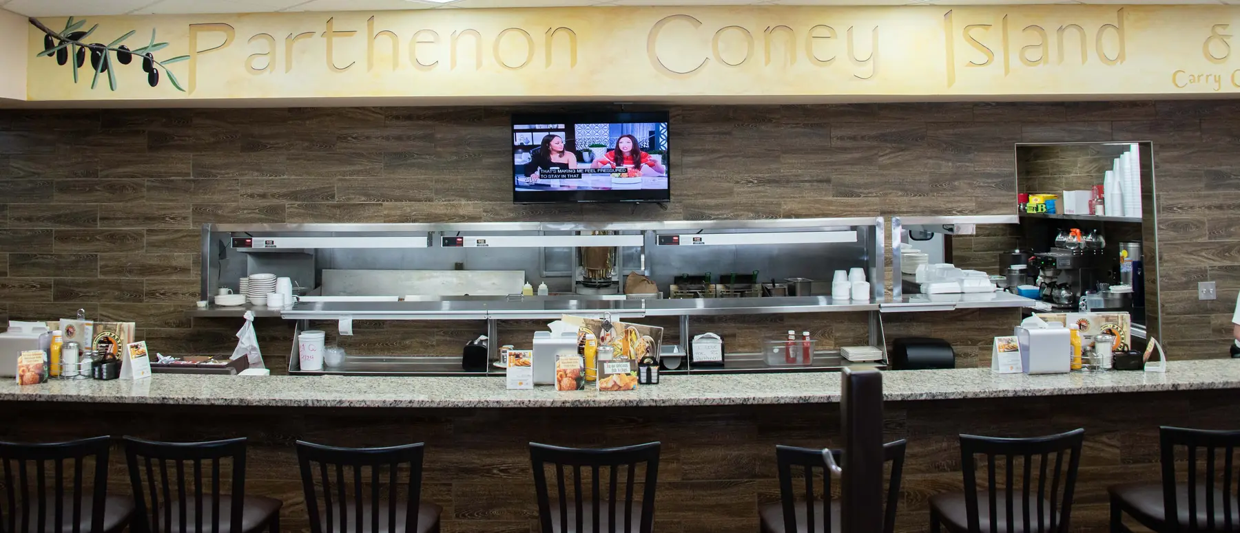 Hand-painted Parthenon Coney Island lettering over a restaurant counter