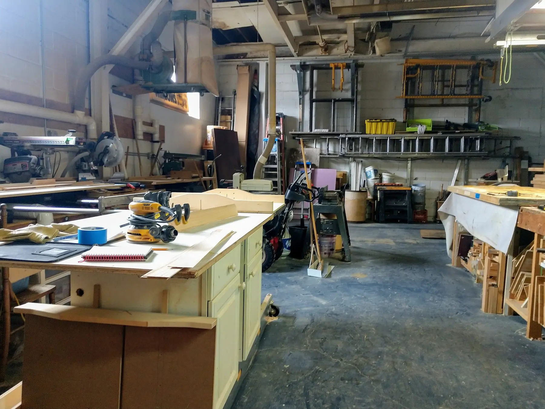 The Sames Inc. wood shop, with benches, tools and lumber racks